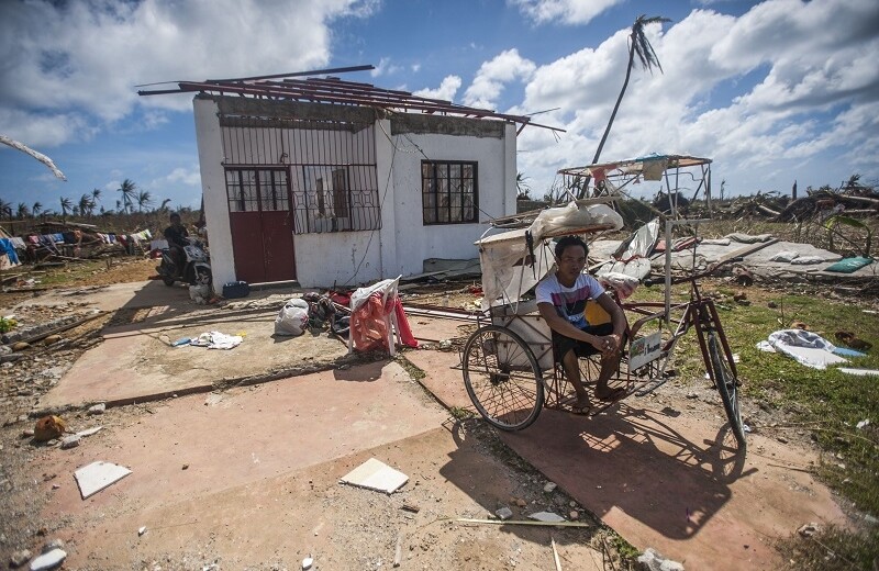 After Super Typhoon Haiyan. CREDIT: <a href="https://commons.wikimedia.org/wiki/File:A_Philippine_resident_sits_outside_of_his_home_in_the_aftermath_of_Super_Typhoon_Haiyan_131115-N-BD107-722.jpg">Kennedy, Liam, MCSN</a>  via Wikimedia Commons