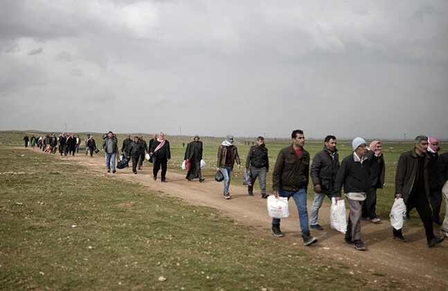 Syrian Refugees, Turkey-Syria Border, February 2015. CREDIT: <a href="www.shutterstock.com/pic-326208443/stock-photo-sanliurfa-turkey-february-syrian-refugees-walking-on-turkey-syria-border-in-suruc-district.html">Shutterstock</a>