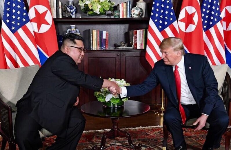 DPRK–USA Singapore Summit,  June 12, 2018. CREDIT: <a href="https://commons.wikimedia.org/wiki/File:Trump_and_Kim_shaking_hands_in_the_summit_room.jpg">Dan Scavino Jr.</a> via Wikipedia, Public Domain