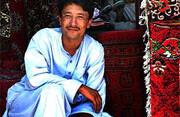 Carpet vendor in Kabul, Afghanistan <br>(2005). Photo by <a href="http://flickr.com/photos/babasteve/25456049/">Steve Evans</a> (<a href="http://creativecommons.org/licenses/by/2.0/deed.en-us">CC</a>).