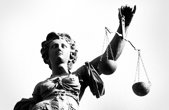 Image via <a href="http://www.shutterstock.com/pic-114542110/stock-photo-justice-statue-in-black-and-white.html">Shutterstock</a>
