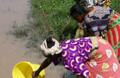 African women collecting <br>muddy waters. Photo <br>courtesy of the <a href="http://www.studentmovementusa.org/" target="_blank">Student <br>Movement for Real Change</a>.