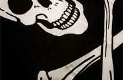 Pirate flag skull and crossbones. Photo by <br><a href="http://flickr.com/photos/nickhumphries/1405653435/">Nick Humphries</a> (<a href="http://creativecommons.org/licenses/by-nc-nd/2.0/deed.en">CC</a>).