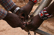 A village well in Kenya is locked for <br>conservation purposes. Photo by <a href="http://flickr.com/photos/davida3/484971270/">Davida <br>De La Harpe</a> (<a href="http://creativecommons.org/licenses/by-nc-nd/2.0/deed.en">CC</a>).