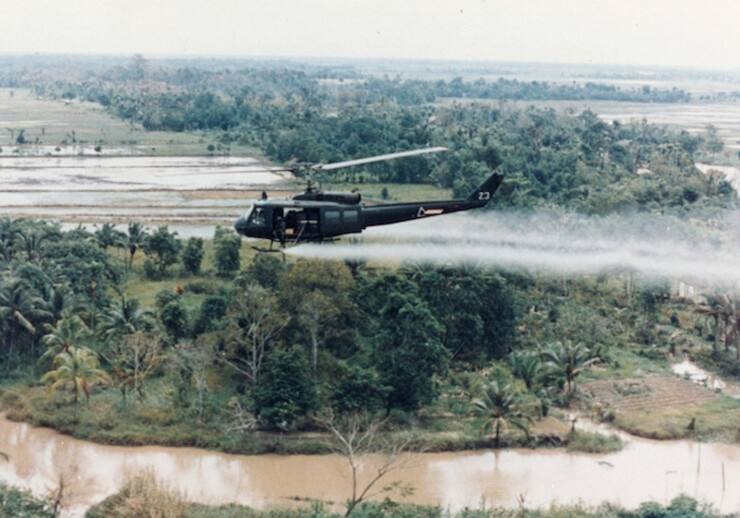 U.S. Huey helicopter spraying Agent Orange over Vietnam. CREDIT: U.S. Army via <a href="https://commons.wikimedia.org/wiki/File:US-Huey-helicopter-spraying-Agent-Orange-in-Vietnam.jpg">Wikipedia</a> (Public domain)