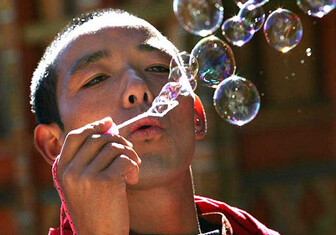 Bhutanese monk blowing bubbles. CREDIT: <a href="http://flickr.com/photos/babasteve/2249740073/">Steve Evans</a> (<a href="http://creativecommons.org/licenses/by/2.0/deed.en">CC</a>).