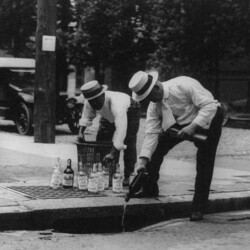 Pouring whiskey into a sewer, 1921. CREDIT: <a href"=https://www.loc.gov/item/2001706109/">Library of Congress</a>