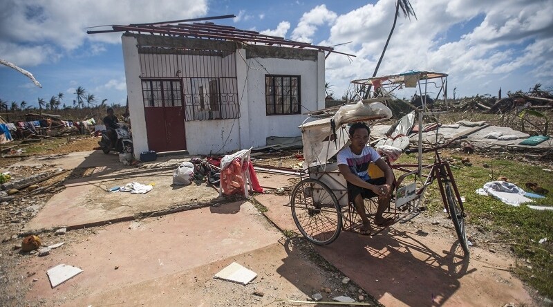 After Super Typhoon Haiyan. CREDIT: <a href="https://commons.wikimedia.org/wiki/File:A_Philippine_resident_sits_outside_of_his_home_in_the_aftermath_of_Super_Typhoon_Haiyan_131115-N-BD107-722.jpg">Kennedy, Liam, MCSN</a>  via Wikimedia Commons