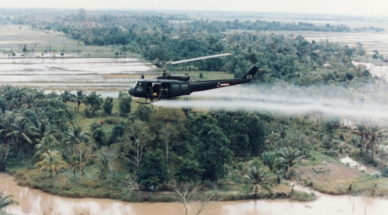 U.S. Huey helicopter spraying Agent Orange over Vietnam. CREDIT: U.S. Army via <a href="https://commons.wikimedia.org/wiki/File:US-Huey-helicopter-spraying-Agent-Orange-in-Vietnam.jpg">Wikipedia</a> (Public domain)