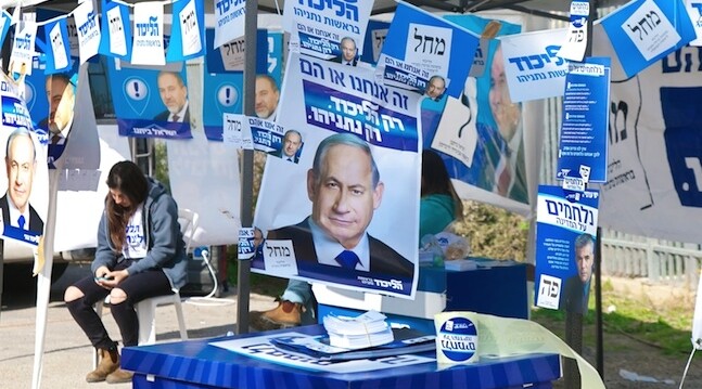 Campaign tent at a Jerusalam voting station, March 17, 2015. Text: "It's us or them. Just Likud. Just Netanyahu." <br>CREDIT: Gali Estrange via <a href="http://tinyurl.com/qdjvf4a">Shutterstock</a>