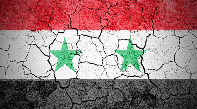 CREDIT: <a href="http://www.shutterstock.com/pic-111913646/stock-photo-the-syria-flag-painted-on-cracked-ground-with-vignette.html?src=2MxIh1ofNEDYTajaWexBqA-1-79">The Syrian flag</a> via Shutterstock