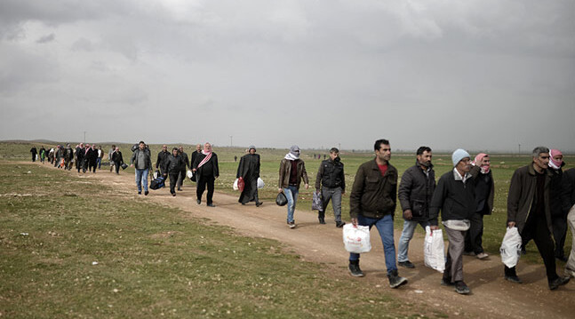 Syrian Refugees, Turkey-Syria Border, February 2015. CREDIT: <a href="www.shutterstock.com/pic-326208443/stock-photo-sanliurfa-turkey-february-syrian-refugees-walking-on-turkey-syria-border-in-suruc-district.html">Shutterstock</a>