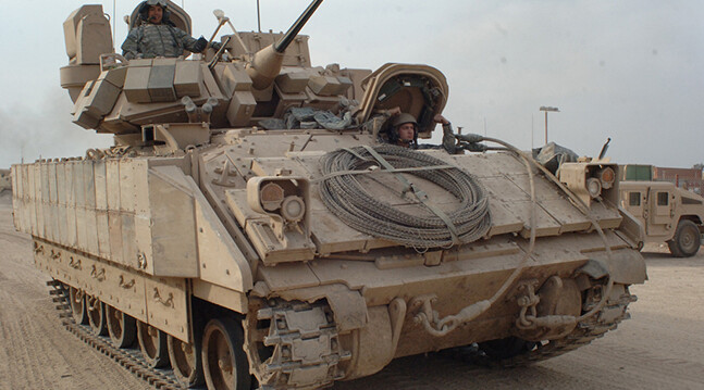 U.S. Army Soldiers drive a Bradley Fighting Vehicle in East Baghdad, Iraq (2007).<br>CREDIT: <a href="https://www.flickr.com/photos/soldiersmediacenter/421323075/">The U.S. Army</a> (<a href="https://creativecommons.org/licenses/by/2.0/">CC</a>)