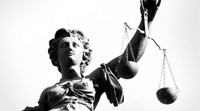 Image via <a href="http://www.shutterstock.com/pic-114542110/stock-photo-justice-statue-in-black-and-white.html">Shutterstock</a>