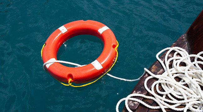 CREDIT: Life Preserver via <a href="http://www.shutterstock.com/pic-105062843/stock-photo-safe-water-support-aid-circle-with-rope-rescue-red-life-buoy-on-wooden-background-of-ship-or-boat.html?src=lb-21249545">Shutterstock</a>