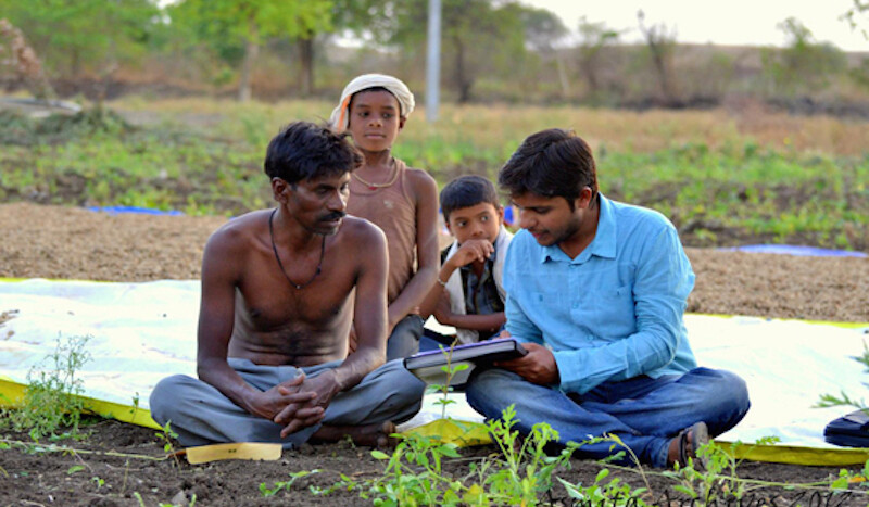 Asmita worker with farmer and his family.  Photo courtesy of Asmita