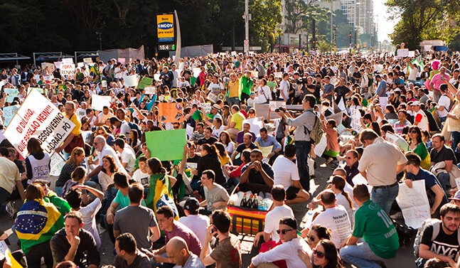 Protesters in Sao Paulo in June 2013 via <a href="http://www.shutterstock.com/pic-190374902/stock-photo-sao-paulo-brazil-june-some-protesters-marching-on-paulista-avenue-holding-signs-with.html?src=9bHtQcDaZEdt6k_Tqv-RUw-1-12">Shutterstock</a>