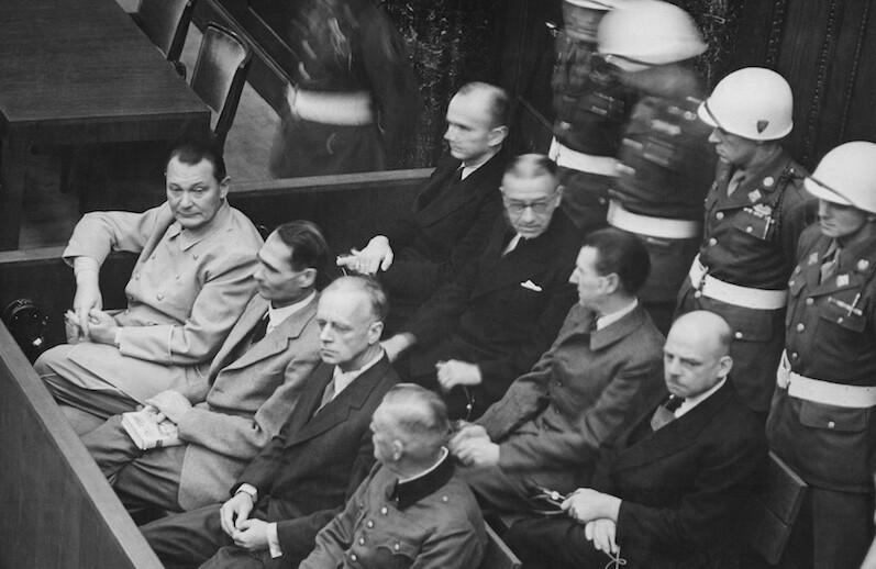 Defendants at the Nuremberg trials, including Hermann Göring (at the left edge on the first row of benches), 1945/1946. <br>CREDIT: <a href="https://commons.wikimedia.org/wiki/File:Nuremberg_Trials_retouched.jpg">U.S.Government/Public Domain</a>