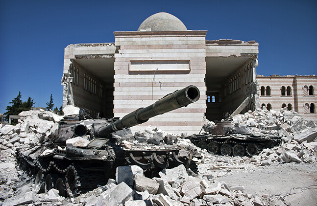 Destroyed tank and mosque in Azaz, Syria via <a href="http://www.shutterstock.com/pic-161912165/stock-photo-azaz-syria-august-a-destroyed-tank-in-front-of-a-similarly-ruined-mosque.html">Shutterstock</a>