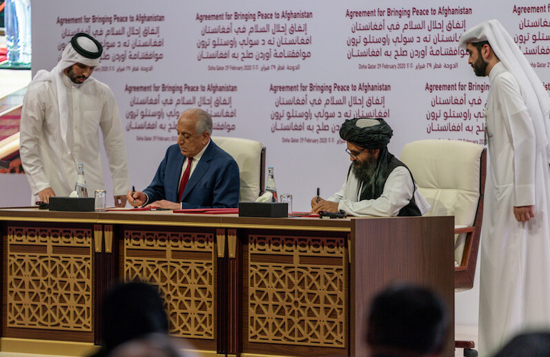 U.S. representative Zalmay Khalilzad (left) and Taliban representative Abdul Ghani Baradar (right) sign the Agreement for Bringing Peace to Afghanistan in Doha, Qatar on February 29, 2020. CREDIT: <a href="https://en.wikipedia.org/wiki/War_in_Afghanistan_(2001–present)#/media/File:Secretary_Pompeo_Participates_in_a_Signing_Ceremony_in_Doha_(49601220548).jpg">U.S. Department of State/Public Domain</a>