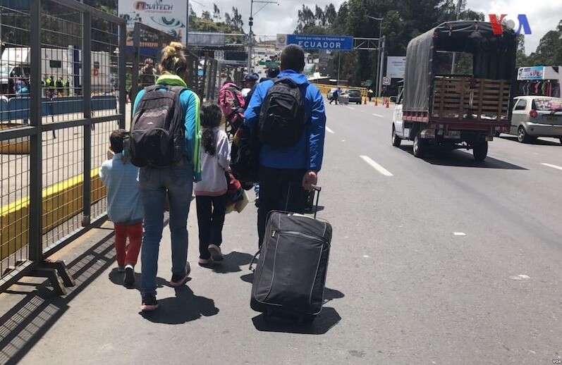 A Venezuelan family at the Colombia/Ecuador border, August 2018. CREDIT: <a href="https://commons.wikimedia.org/wiki/File:This_Venezuelan_family_hopes_to_cross_the_border_between_Ecuador_and_Colombia_on_their_return_trip_to_Venezuela.jpg">Voice of America/Public Domain</a>