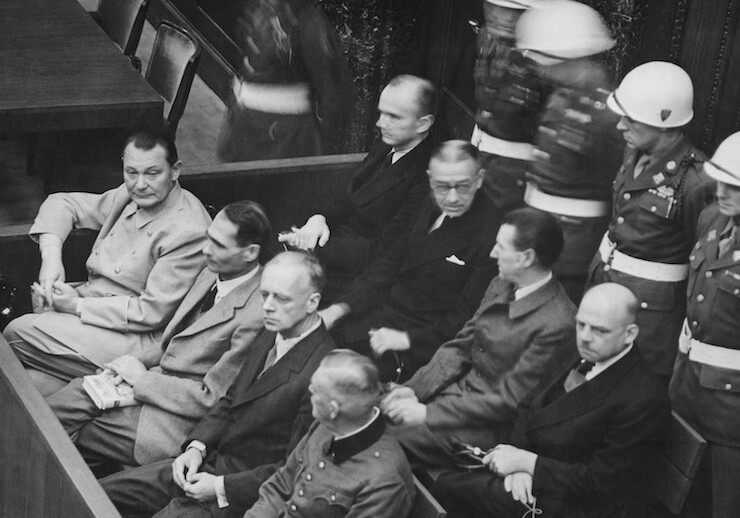 Defendants at the Nuremberg trials, including Hermann Göring (at the left edge on the first row of benches), 1945/1946. <br>CREDIT: <a href="https://commons.wikimedia.org/wiki/File:Nuremberg_Trials_retouched.jpg">U.S.Government/Public Domain</a>