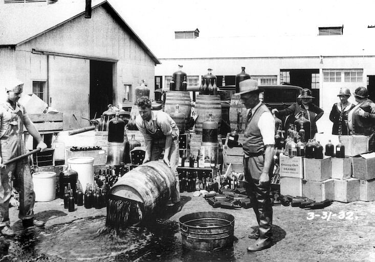 Orange County Sheriff's deputies dumping illegal alcohol, Santa Ana, California, 1932. CREDIT: <a href="https://commons.wikimedia.org/wiki/File:Orange_County_Sheriff%27s_deputies_dumping_illegal_booze,_Santa_Ana,_3-31-1932.jpg">Orange County Archives/(CC)</a>