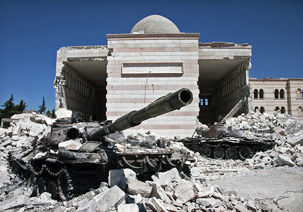 Destroyed tank and mosque in Azaz, Syria via <a href="http://www.shutterstock.com/pic-161912165/stock-photo-azaz-syria-august-a-destroyed-tank-in-front-of-a-similarly-ruined-mosque.html">Shutterstock</a>