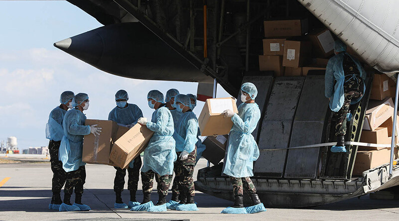 Aid packages from China are unloaded at the Villamor Air Base in Pasay City, Philippines on March 21, 2020. CREDIT: <a href=https://commons.wikimedia.org/wiki/File:China_COVID19_test_kit_PH_donation_7.jpg> Philippines Presidential Communications Operations Office (CC)</a>.