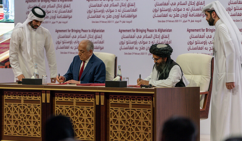U.S. representative Zalmay Khalilzad (left) and Taliban representative Abdul Ghani Baradar (right) sign the Agreement for Bringing Peace to Afghanistan in Doha, Qatar on February 29, 2020. CREDIT: <a href="https://en.wikipedia.org/wiki/War_in_Afghanistan_(2001–present)#/media/File:Secretary_Pompeo_Participates_in_a_Signing_Ceremony_in_Doha_(49601220548).jpg">U.S. Department of State/Public Domain</a>